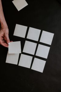 A woman's hand and a grid of sticky notes